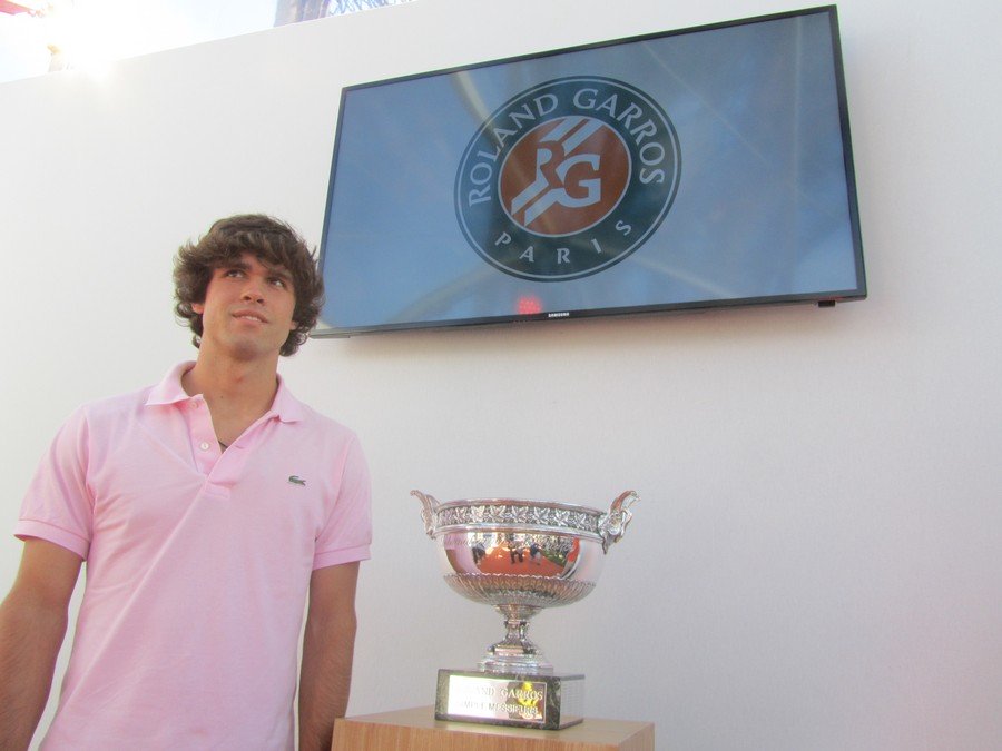 Jaime, grown up, next to the Roland Garros trophy